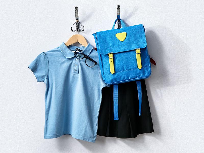 This image shows a picture of school uniform and bag