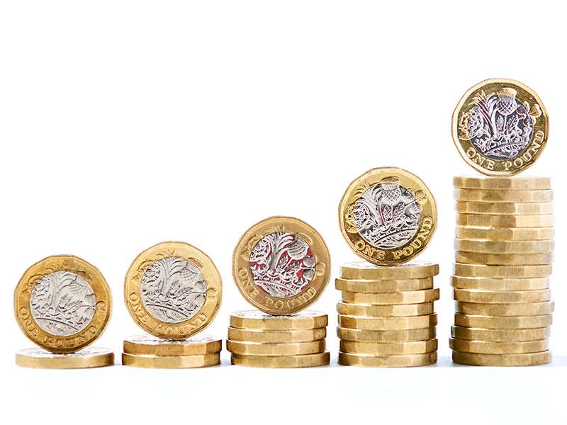 This image shows pound coins being stacked up