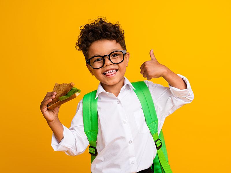 This image shows a young child going to school with a bag.
