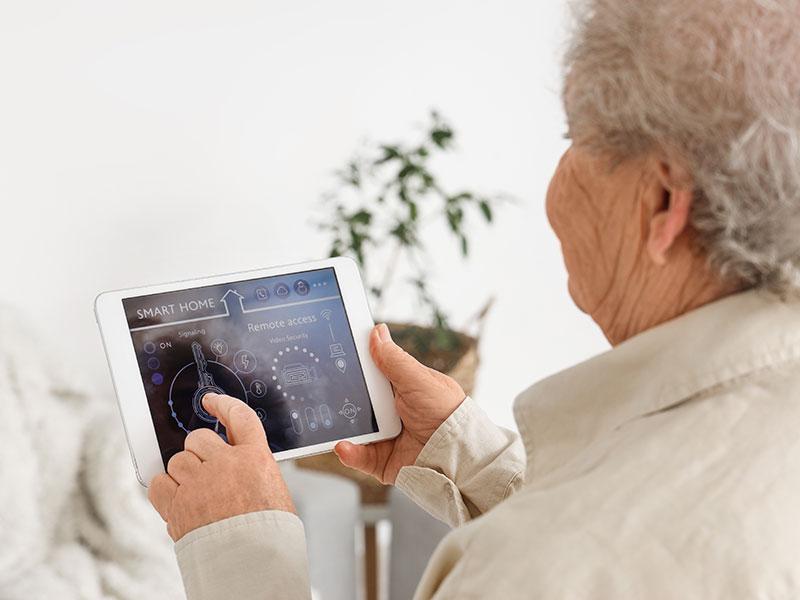 This shows an elderly woman using care technology