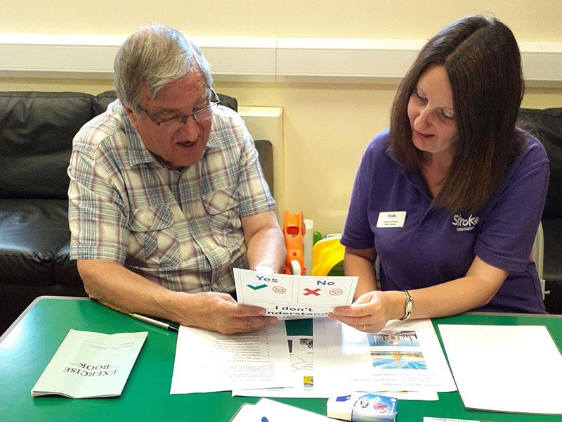 This shows someone receiving help by a stroke support worker