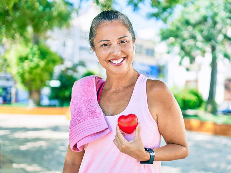 This shows a woman holding a healthy heart