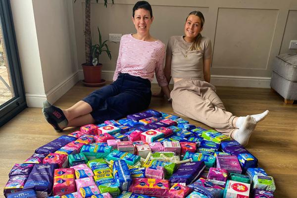 Two women with period products