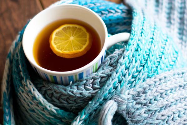 Mug of herbal tea wrapped in a scarf