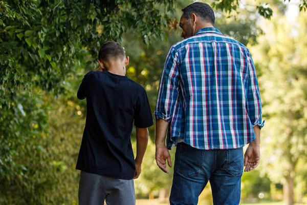 adult man and young boy walking