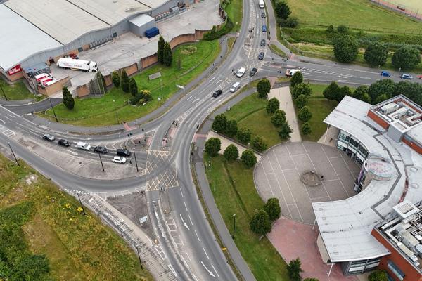An aerial view of the Queensway junction, showing the intersection of two roundabouts with buildings on each side