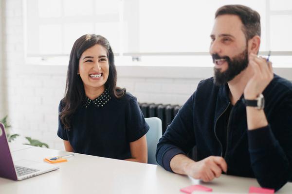 man and woman talking in a meeting