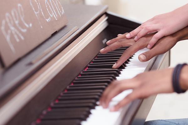 close up of someone playing piano