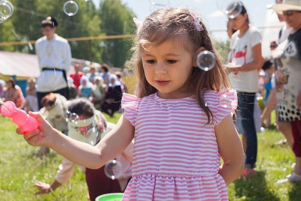 young girl playing with bubbles