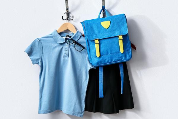 This image shows a picture of school uniform and bag