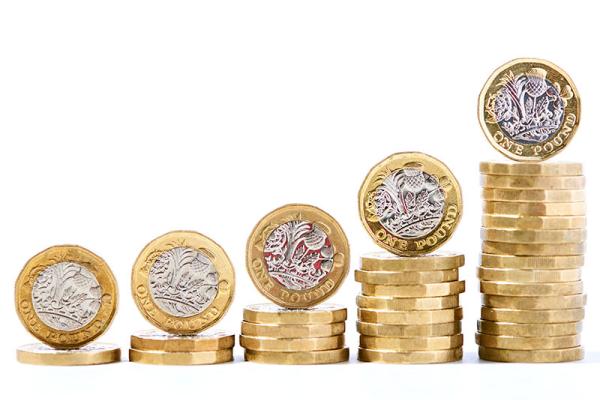 This image shows pound coins being stacked up