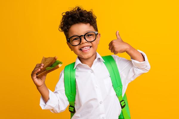 This image shows a young child going to school with a bag.