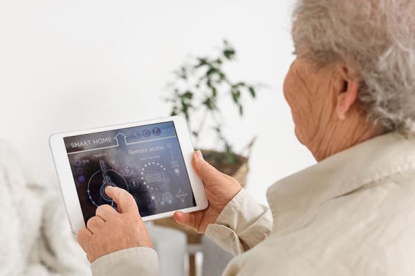 This shows an elderly woman using care technology