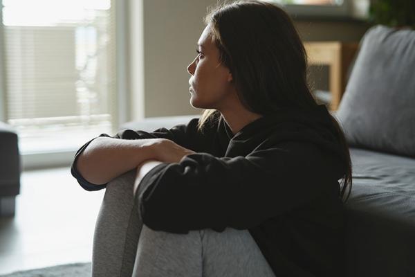 This shows a woman looking worried at home