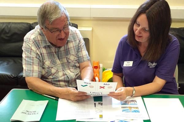 This shows someone receiving help by a stroke support worker