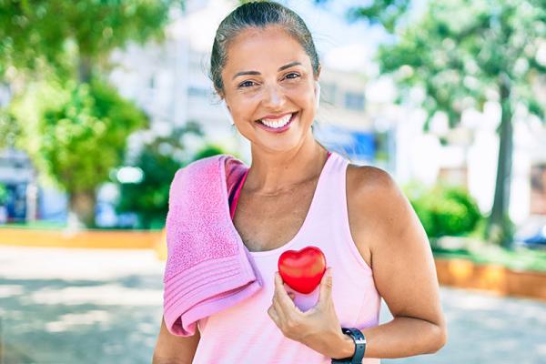 This shows a woman holding a healthy heart