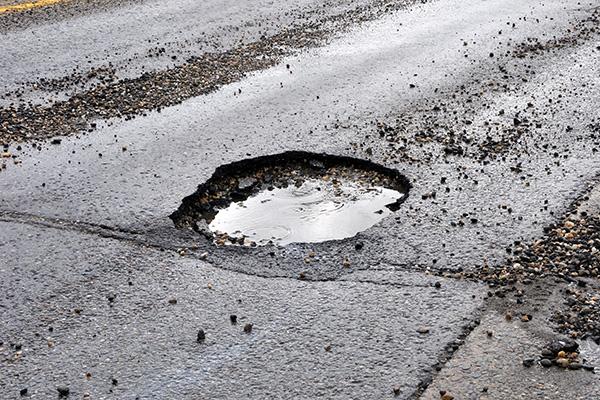 This shows a pothole in the road